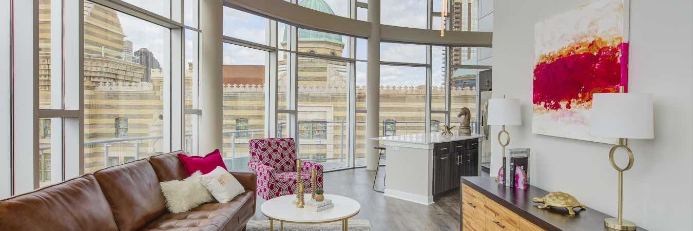 Living room area of penthouse apartment with glass wall