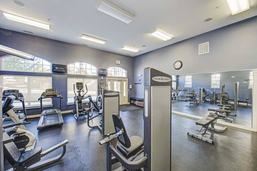 Fitness center with aerobic and strength training equipment at apartment complex